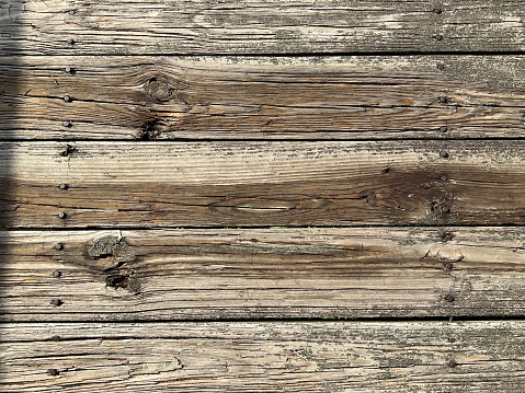 Texture of weathered wood boards and nails from a pier located on Beaverfork Lake in Central Arkansas.