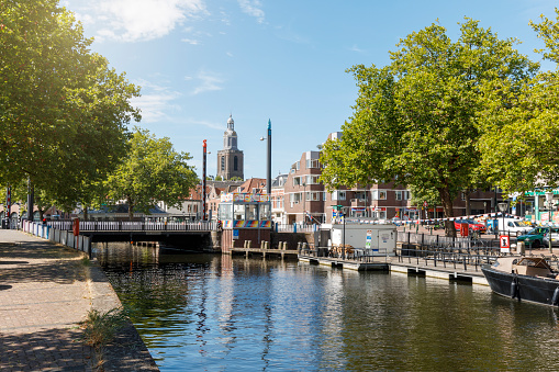 Vlaardingen, The Netherlands - july, 2022: sunny summer sunday at the old harbor bridge and church tower in Vlaardingen