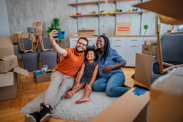 istock Multi-ethnic family making selfie in their new home 1410653620