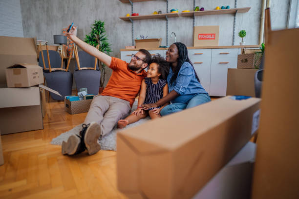 istock Multi-ethnic family making selfie in their new home 1410654341