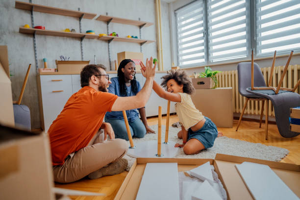 istock Father and daughter set up a coffee table in their new home 1410654821