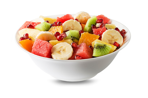 Bowl of healthy fresh mixed fruit salad isolated on white background