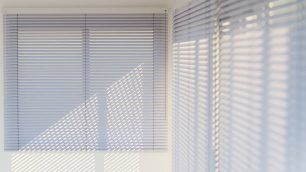 istock White Venetian blinds with sunlight and shadow. Window blinds. 3d rendering. 1410656240