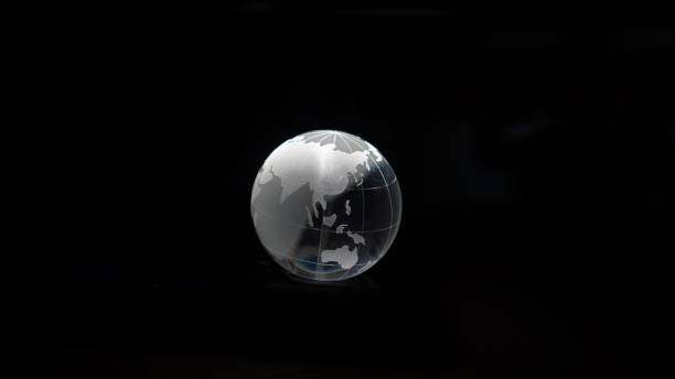 istock Glass crystal globe ball shine in dark background with black copy space internation global concept 1410656258