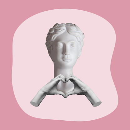 Young woman headed by antique statue showing a heart shape with hands isolated on a pink color background. 3d illustration. Trendy collage in magazine style. Contemporary art. Modern design