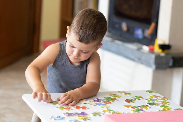 istock Little cute boy playing puzzle at home 1410656852
