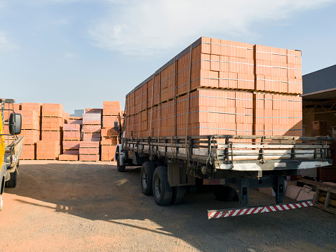 Photo of a truck loaded with bricks at a construction materials store.