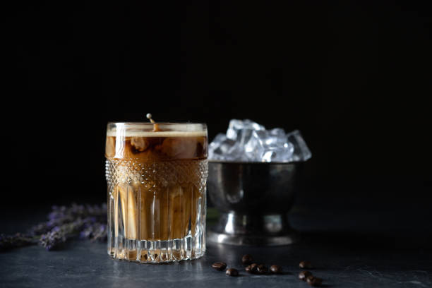 istock Glass cold brew coffee with ice and milk on black or dark background. 1410661996