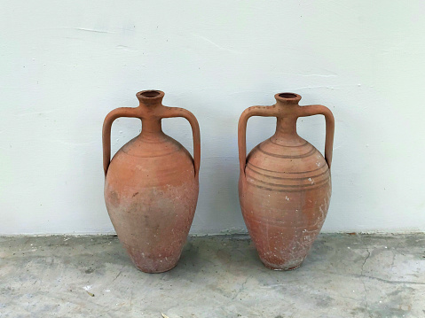 Typical sicilian Ceramic Pot sitting on a coloumn pedestal in a garden during sunrise