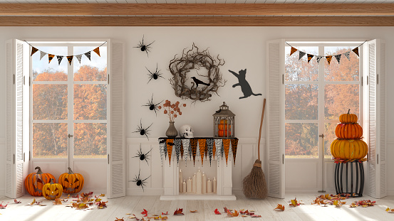 Halloween interior design, living room with fireplace in white tones. Panoramic windows on autumnal landscape. Party decorations, modern scandinavian style