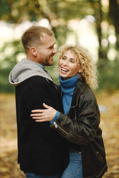 istock Romantic couple standing in a forest, hugging and posing for a photo 1410665690