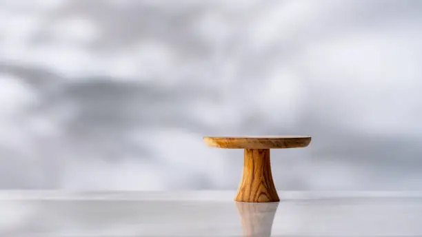Empty wooden cake stand on white background.