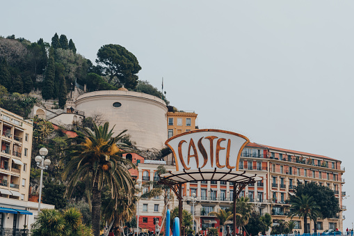 Nice, France - March 11, 2022: Sign by the entrance to Castel, a seaside restaurant offering Mediterranean cuisine and beach rentals, on Promenade des Anglais.