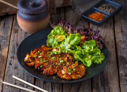 CHICKEN TERIYAKI served in a dish isolated on wooden background side view of Teppanyaki