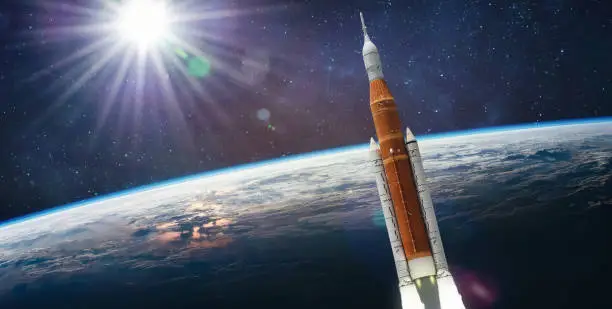 Spaceship launch from Earth. Artemis space program. Expedition to Moon. Space launch system SLS. Elements of this image furnished by NASA (url: https://www.nasa.gov/sites/default/files/styles/full_width_feature/public/thumbnails/image/iss063e074377.jpg https://www.nasa.gov/sites/default/files/styles/full_width_feature/public/thumbnails/image/sls_block1_noeas_afterburner_engmarkings_sm_1.jpg)