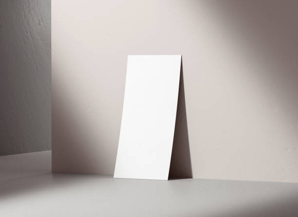 istock Single flyer mockup blank paper leaning on a concrete wall for design presentation. White empty leaflet template with shadows on the background in 3D illustration 1410670998