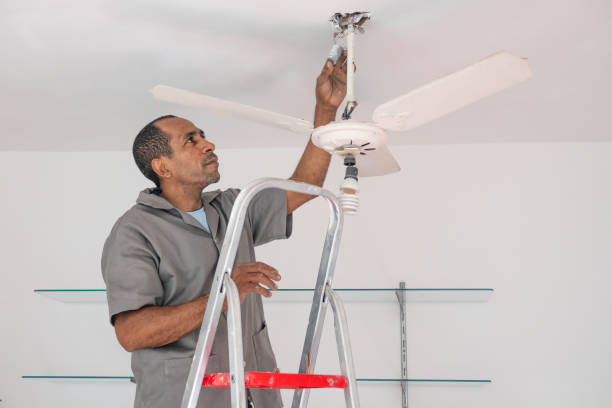 istock Electrician repairs the ceiling fan 1410673632