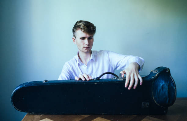 istock The young musician and his instrument. 1410673704