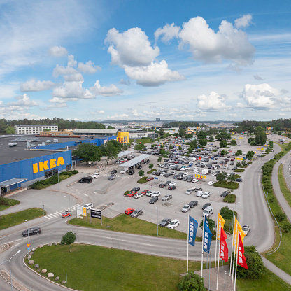 Järfälla, Sweden - July 1, 2022: Many cars at the parking lot outside the IKEA Barkarby store in Stockholm.