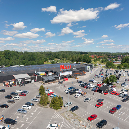 Haninge, Sweden - July 3, 2022: View over an ICA Maxi supermarket and parking lot in Haninge outside Stockholm, Sweden.