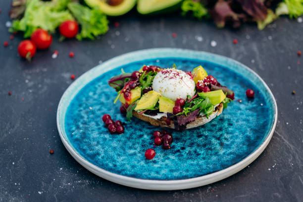 istock Whole wheat toasted bread with avocado, poached egg, soft cheese and mix salad. Healthy diet food breakfast 1410676776