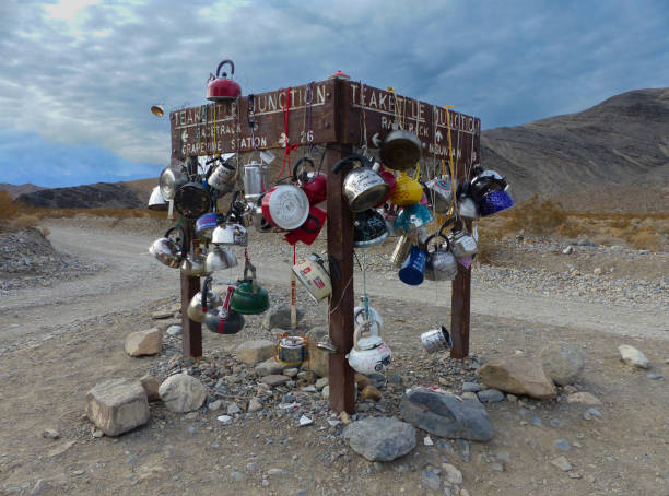 Teakettle Junction, Death Valley National Park Along a remote dirt road in California's Death Valley is an interesting junction where travelers leave teapots either inscribed with a message or with a letter inside, all said to be good omens. teakettle junction stock pictures, royalty-free photos & images