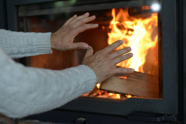 mature adult man lights up the fireplace