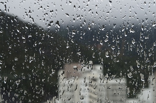 Raining outside window ( view of Hong Kong residential area )