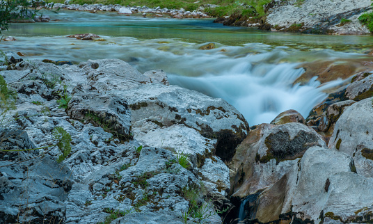Light blue water in Soca river in summer hot evening in Slovenia mountains