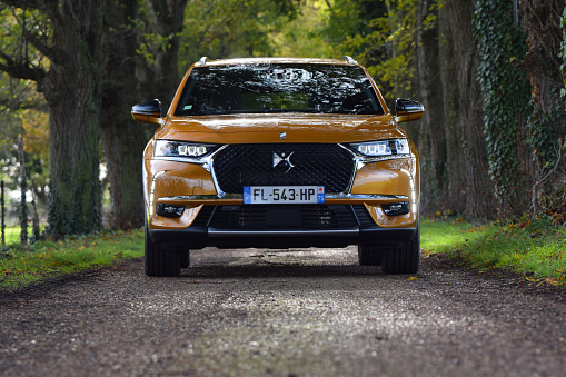 Rambouillet, France - 13 November, 2019: DS 7 Crossback E-Tense in plug-in hybrid version parked on a road. This vehicle is the most luxury car in DS offer on the European market.