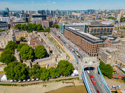 London, UK - July 8, 2022: Aerial photo Tower of London and double decker busses with tourists