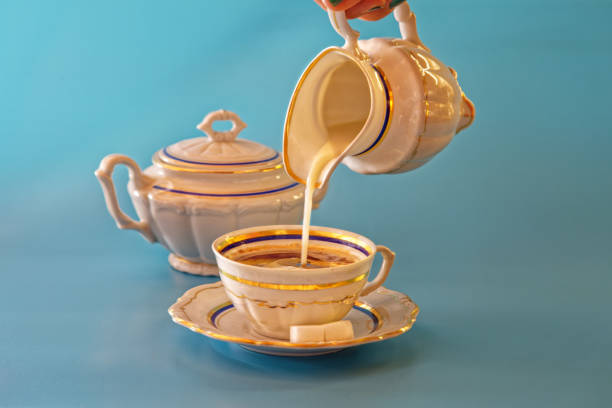 istock vintage white gold coffee set on blue background 1410679739