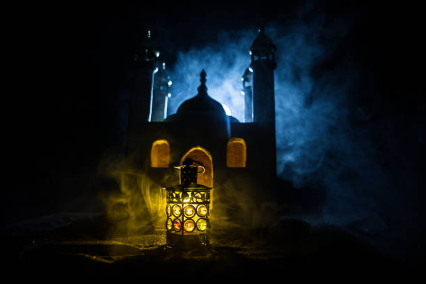 istock Ornamental Arabic lantern with burning candle glowing at night. Festive greeting card, invitation for Muslim holy month Ramadan Kareem. 1410679782
