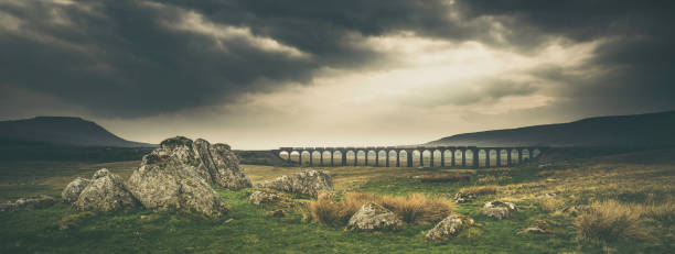 Ribblehead Viaduct & Ingleborough from Batty Green Ribblehead Viaduct and Ingleborough view with freight train on the Settle-Carlisle railway. ingleborough stock pictures, royalty-free photos & images