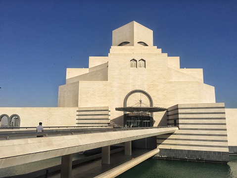 Doha, Qatar - January 6, 2018: Front view of Qatar‘s national Museum of Islamic Art that is located near Doha‘s famous Corniche promenade. The museum showcases Islamic artifacts from three continents dating back up to 1,400 years.