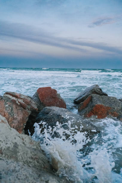 istock Ocean washing over rocks during sunset 1410685550