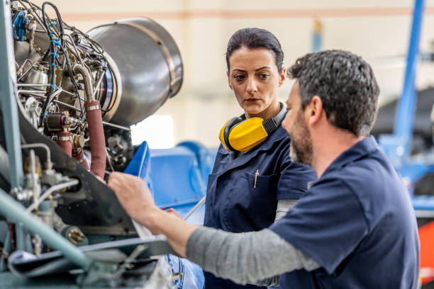 istock Male and female aviation engineers talking, side view 1410686336