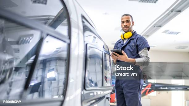 African American Mechanic Standing Near Jet And Looking At Camera Side View Stock Photo - Download Image Now