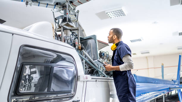 istock African American mechanic standing near jet and fixing propeller engine, side view 1410686350