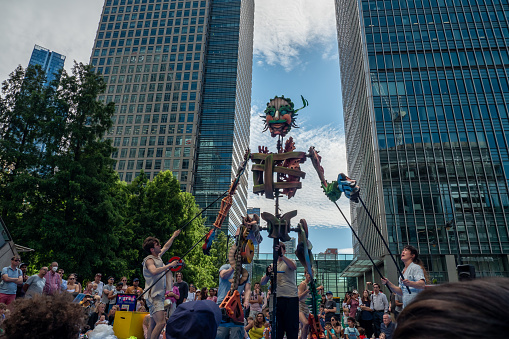 Canary Wharf, London, England - July 24, 2022: Autin Dance Theatre: Out of the deep blue in Jubilee Plaza, outdoors. The magical story of a 4 metre tall pupet caled Eko, who rises from the deep blue.