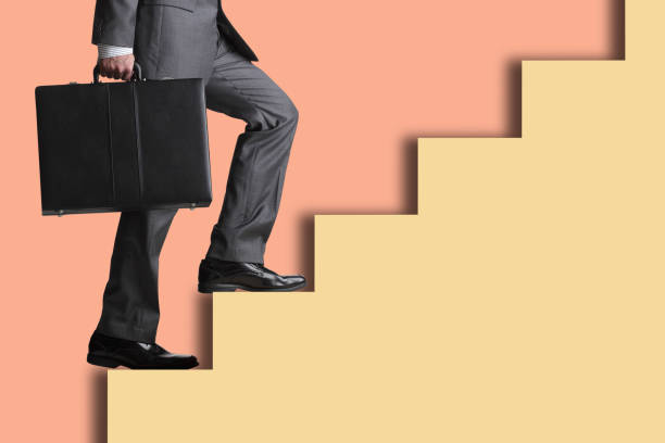 istock Man Climbing Set Of Steps 1410689402