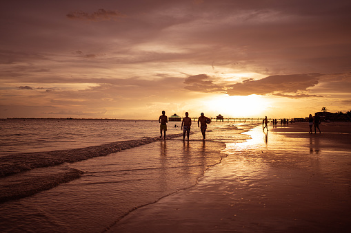 Boys walking on the beach in Florida