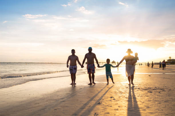 istock Latin family walking on the beach at sunset 1410692665