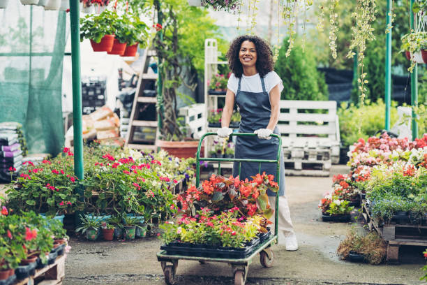 Garden center worker in a flower greenhouse