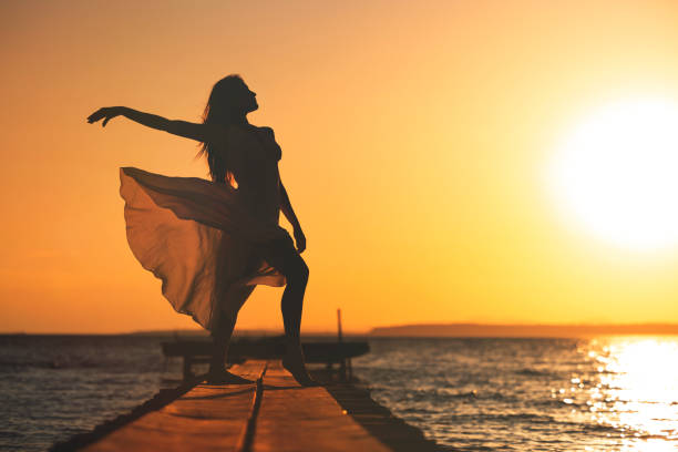 Young woman have fun on the beach with white summer dress. Beauty concept, health care concept, summer time