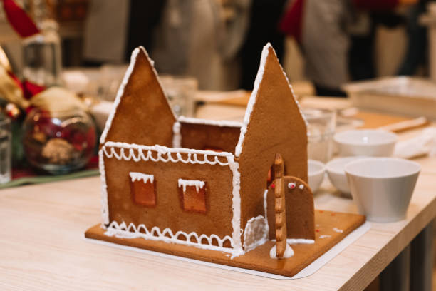 making a gingerbread house, standing on a table without a roof, smeared with icing stock photo