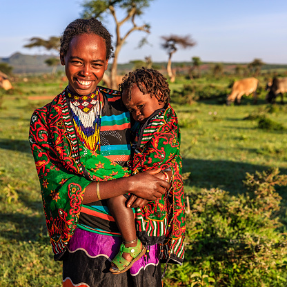 Woman from Borana tribe holding her baby, southern Ethiopia, Africa. The Borana Oromo are a pastoralist tribe living in southern Ethiopia and northern Kenya.