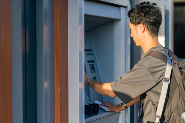 istock Male tourist using atm during his travel 1410704104