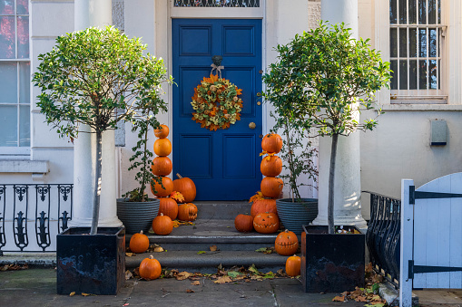 London, United Kingdom - November 01, 2022: Blue door with pumpkin Halloween displays