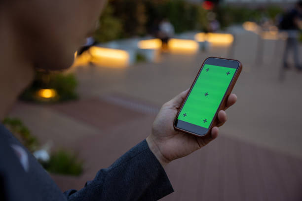 istock Man looking at screen on smart phone in city at twilight time 1410705749